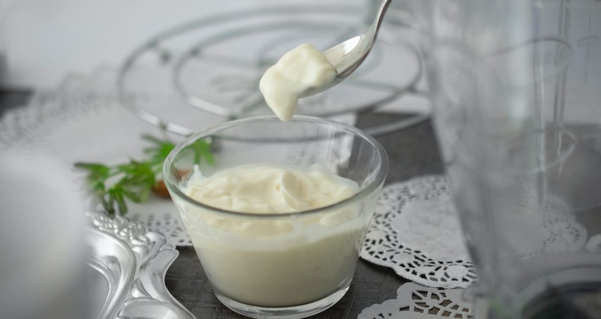 close-up photo of white cream in clear shot glass