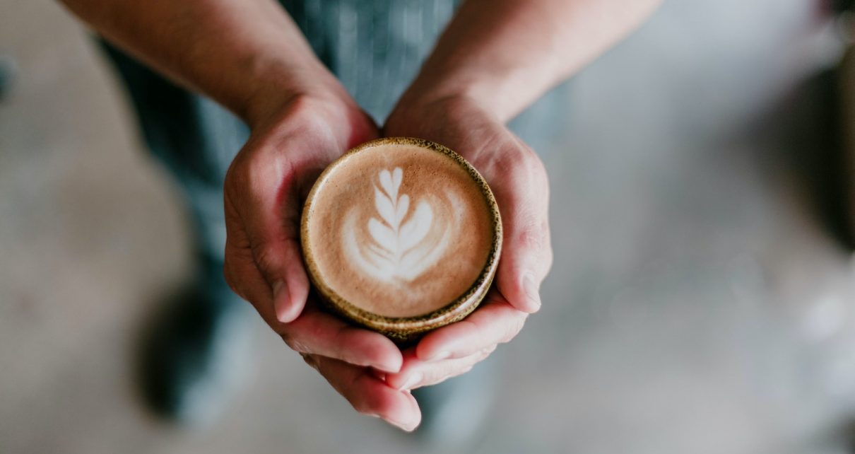 person holding coffee cup