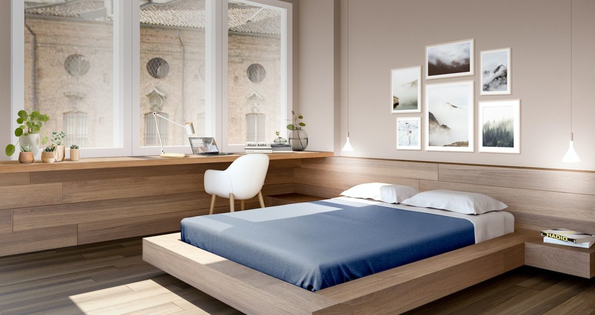 a bed room with a neatly made bed and a desk