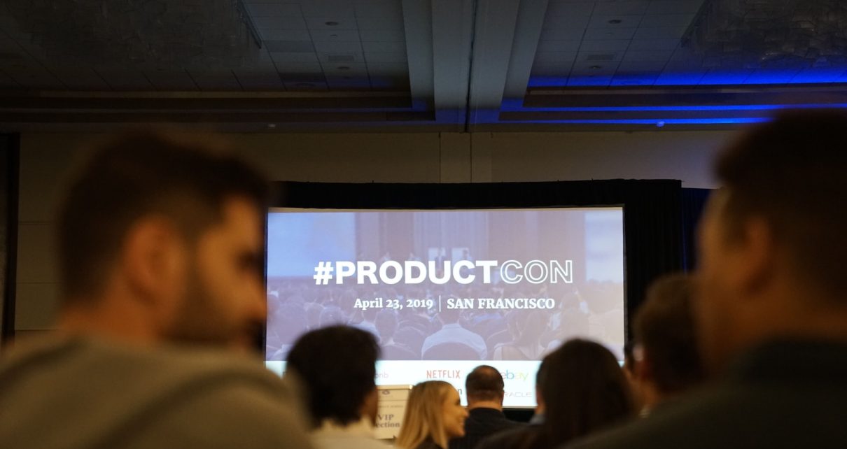 people in conference with projector screen in front